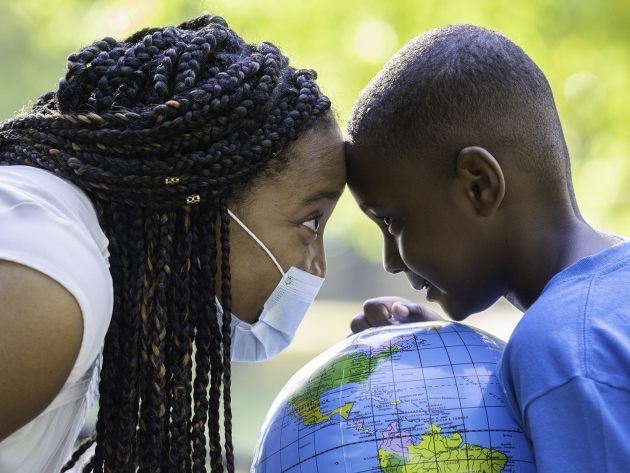 african american mother and son with heads together