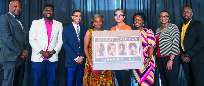 a group of people holding a sign