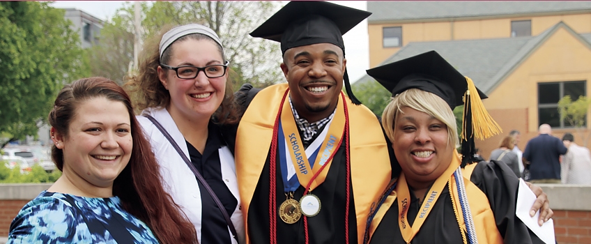 a group of people in graduation gowns and caps